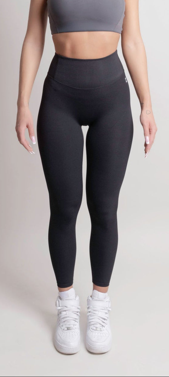 Woman wearing NOIR sport top and leggings front view by ZANOS Apparel