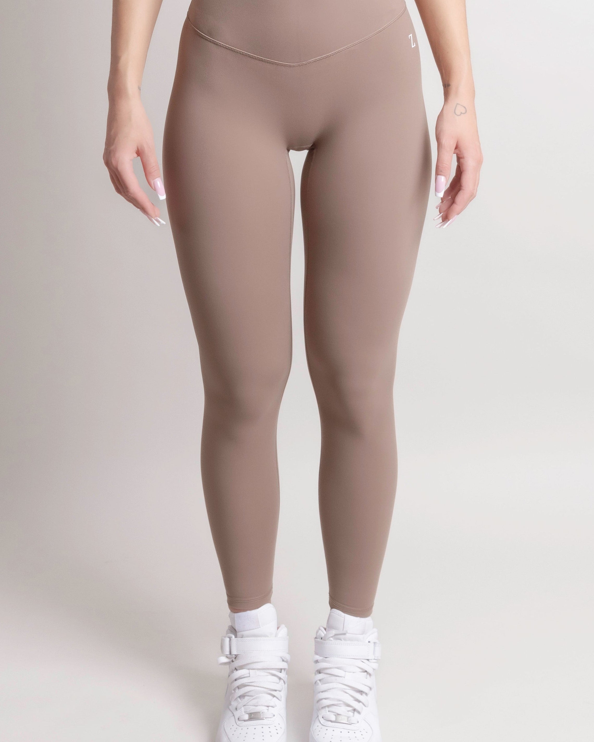 Woman wearing black NOIR Sculpt leggings by ZANOS Apparel