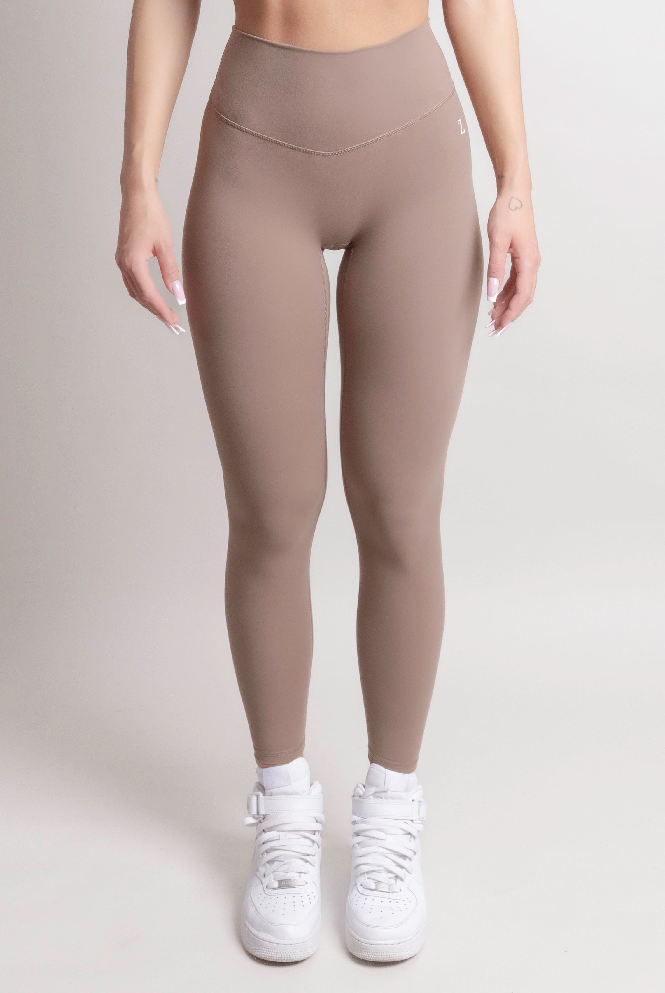 Woman wearing black NOIR Sculpt leggings by ZANOS Apparel