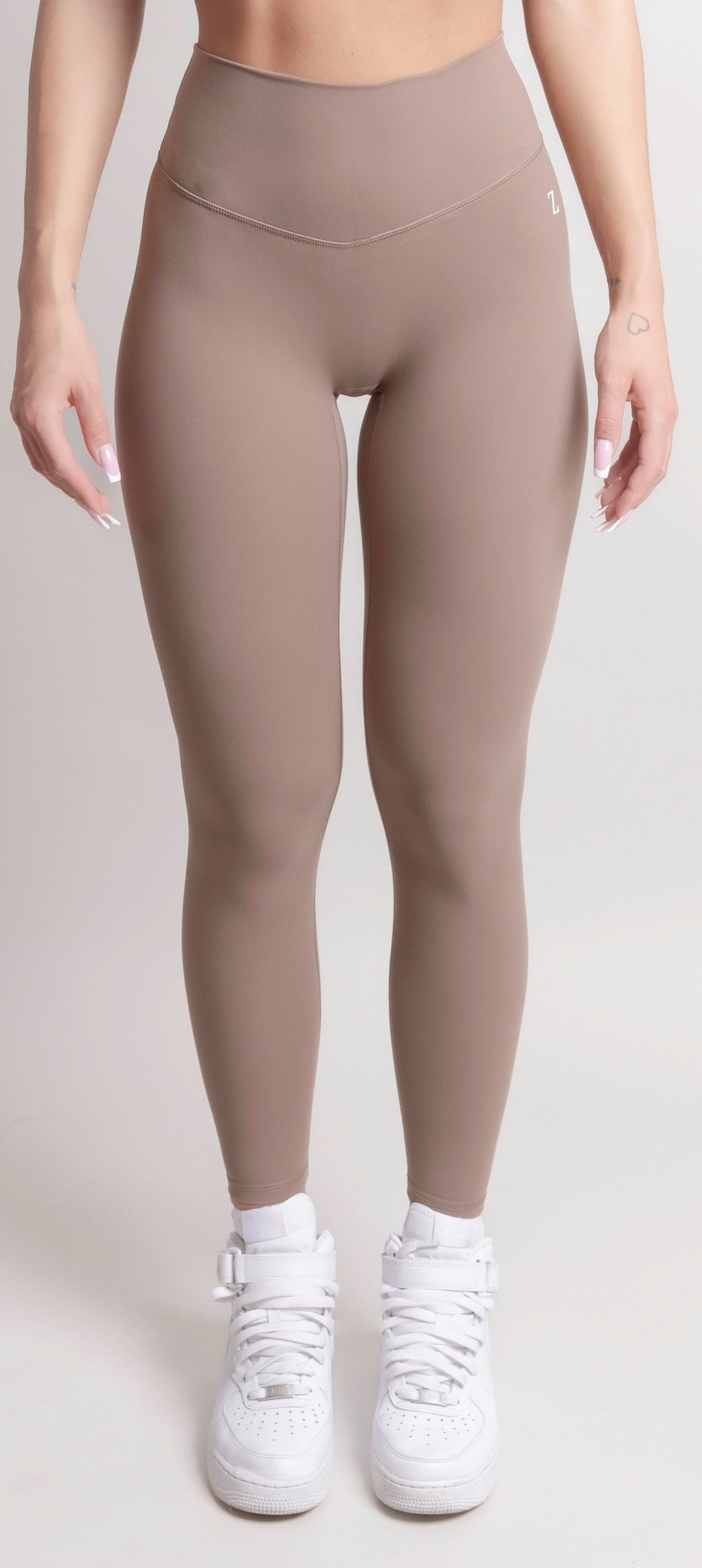 Woman wearing black NOIR Sculpt leggings by ZANOS Apparel