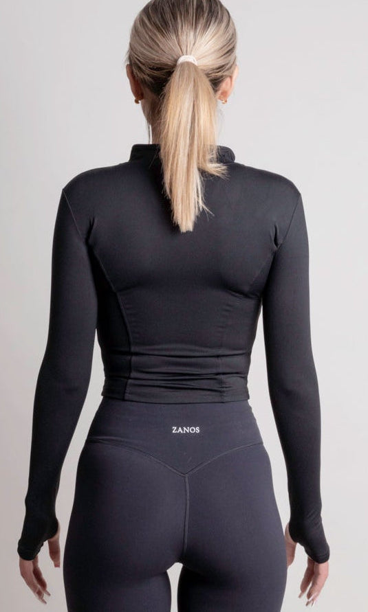 NOIR zip jacket black women seen from the back, showcasing a sleek silhouette and lightweight fabric.