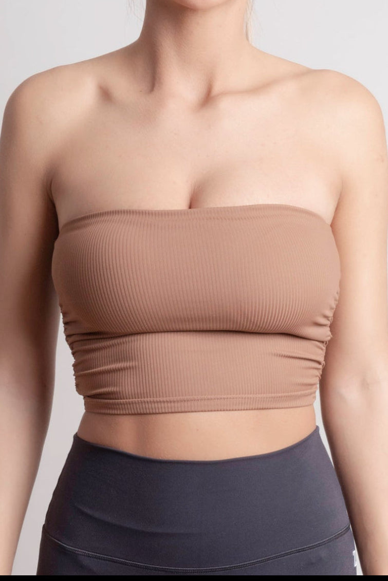 NOIR bandeau top earth brown model wearing seamless ribbed bandeau top, perfect for studio flow and summer nights.