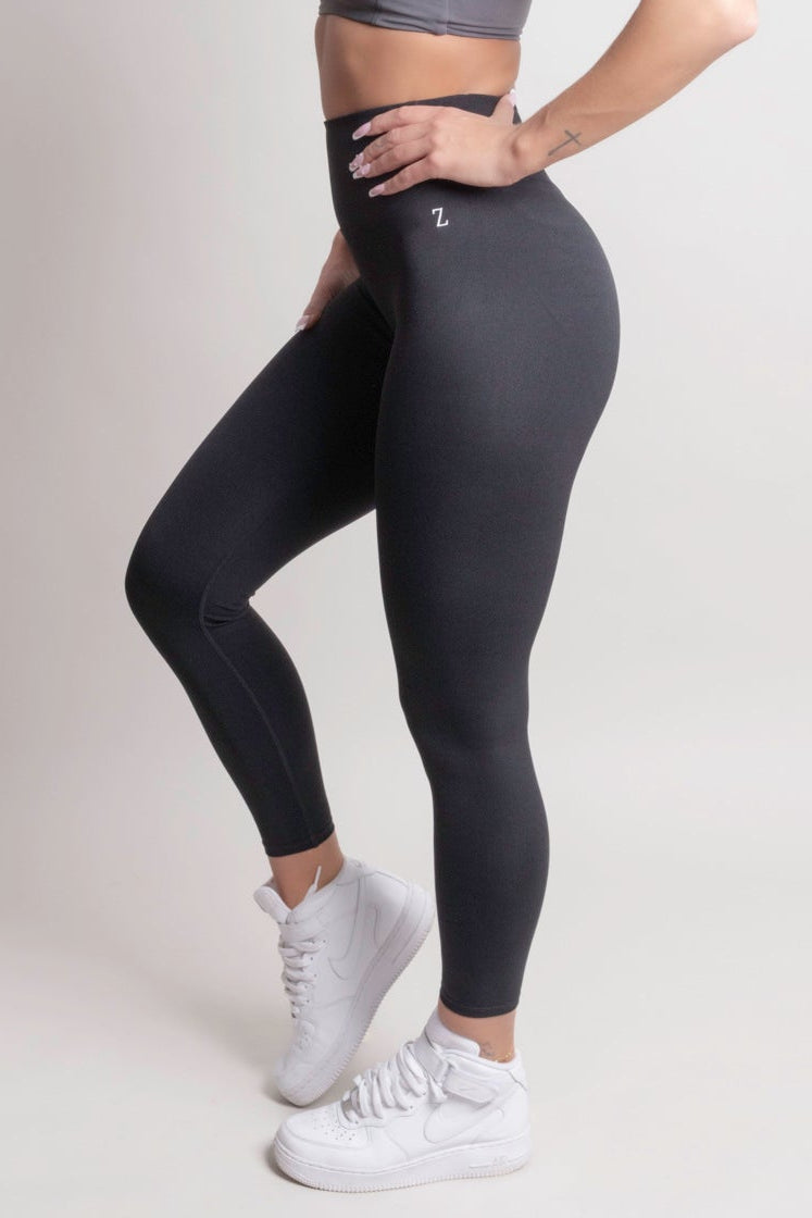 Model wearing NOIR CloudFit leggings black and a matching sports bra, showcasing comfort and style.