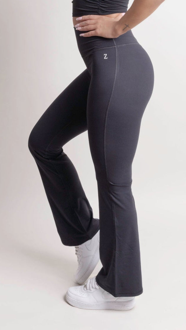 Model wearing NOIR Flare Pants Black showcasing a flattering fit and flared leg design, emphasizing a stylish silhouette.