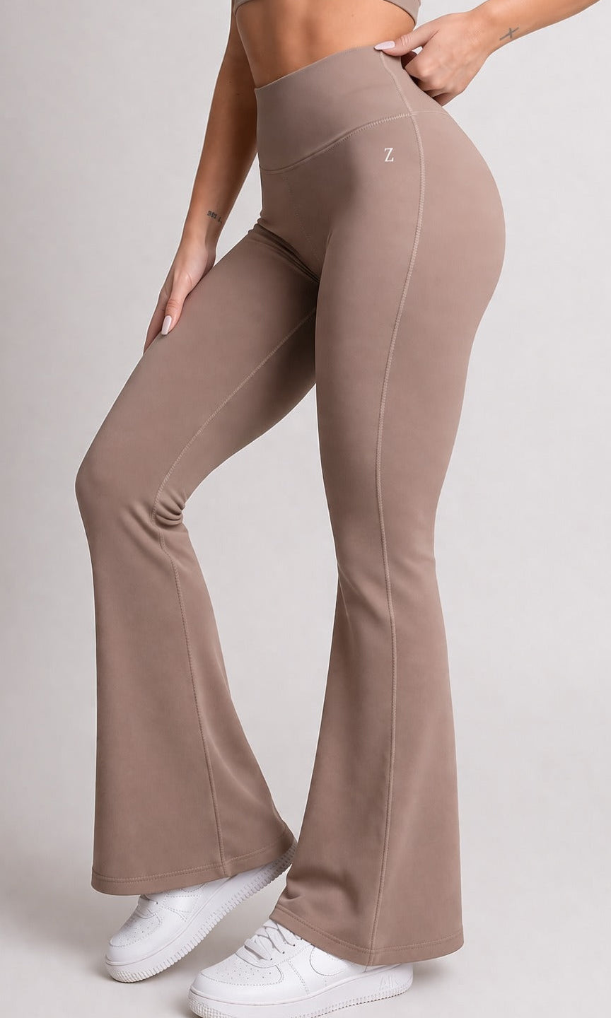 Woman wearing NOIR Flare Pants Brown with matching top, showcasing a flattering silhouette and stylish look.