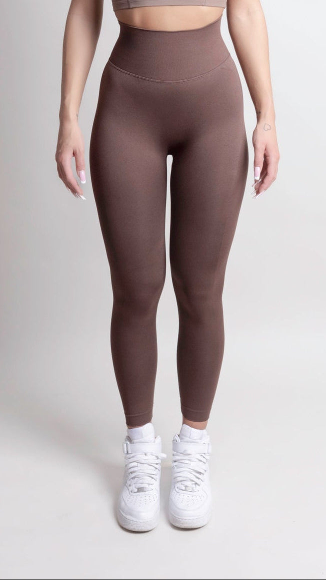 Women wearing NOIR Scrunch Leggings Mocha Brown, showcasing a flattering body-hugging fit and scrunch detail, paired with white sneakers.