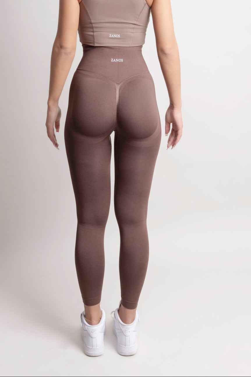 Back view of a model wearing NOIR Scrunch Leggings Mocha Brown with a matching top, showcasing scrunch detail and body-hugging fit.