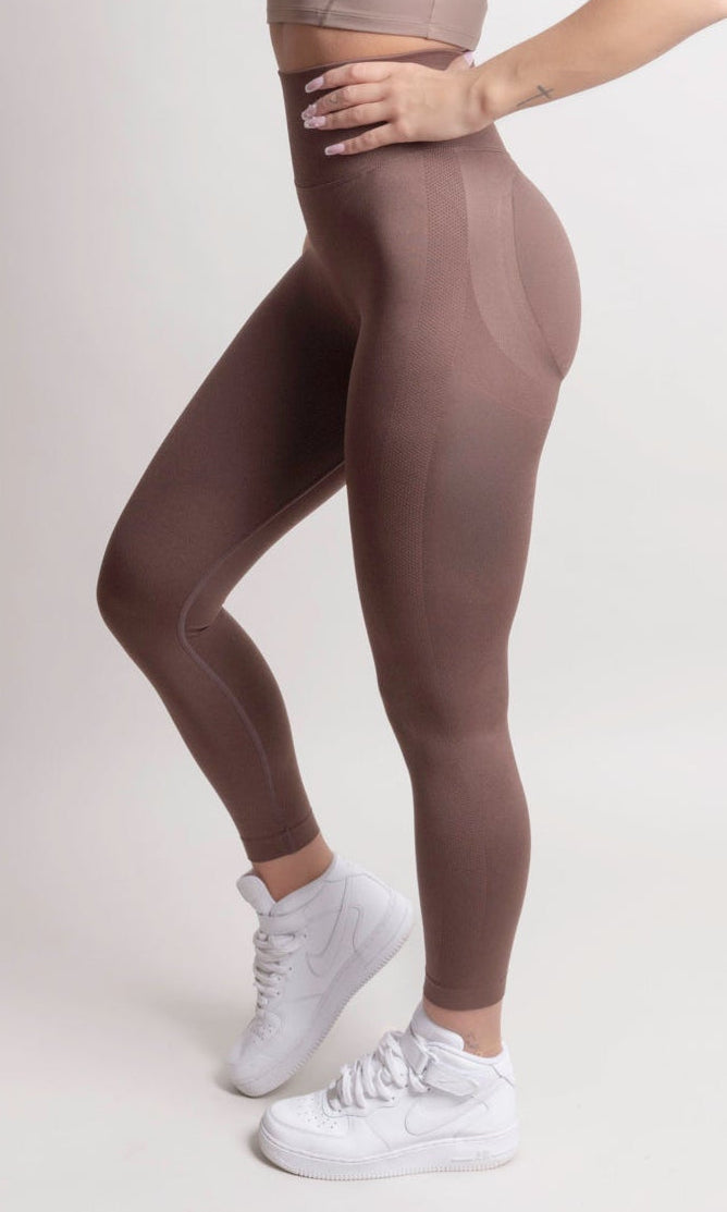 Model wearing NOIR Scrunch Leggings in Mocha Brown, showcasing the flattering scrunch detail and body-hugging fit.