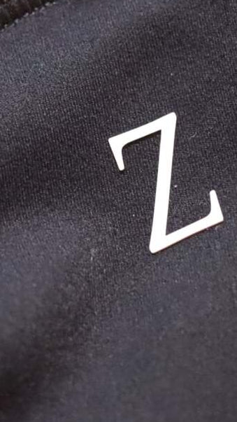Close-up of a black fabric surface with a white 'Z' logo.