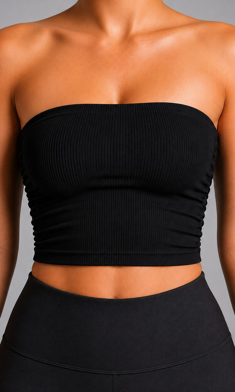 Woman wearing NOIR Bandeau Top in Black, side view.