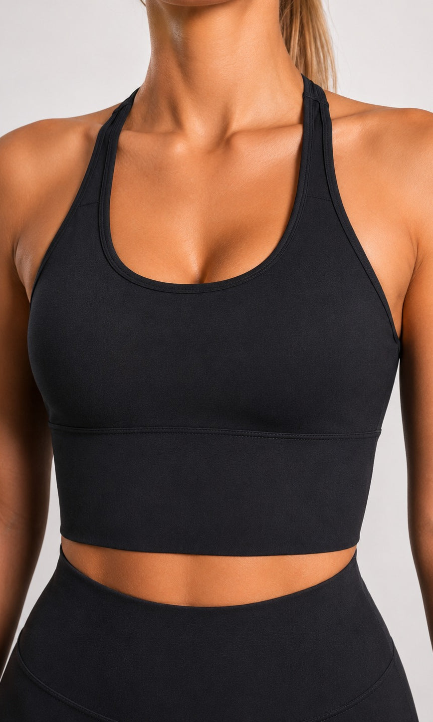 Woman wearing NOIR Cross Top in Black, side view.