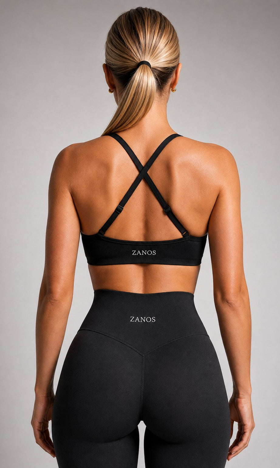 Side view of black NOIR Flow Bra showing the fitted cut and supportive underband