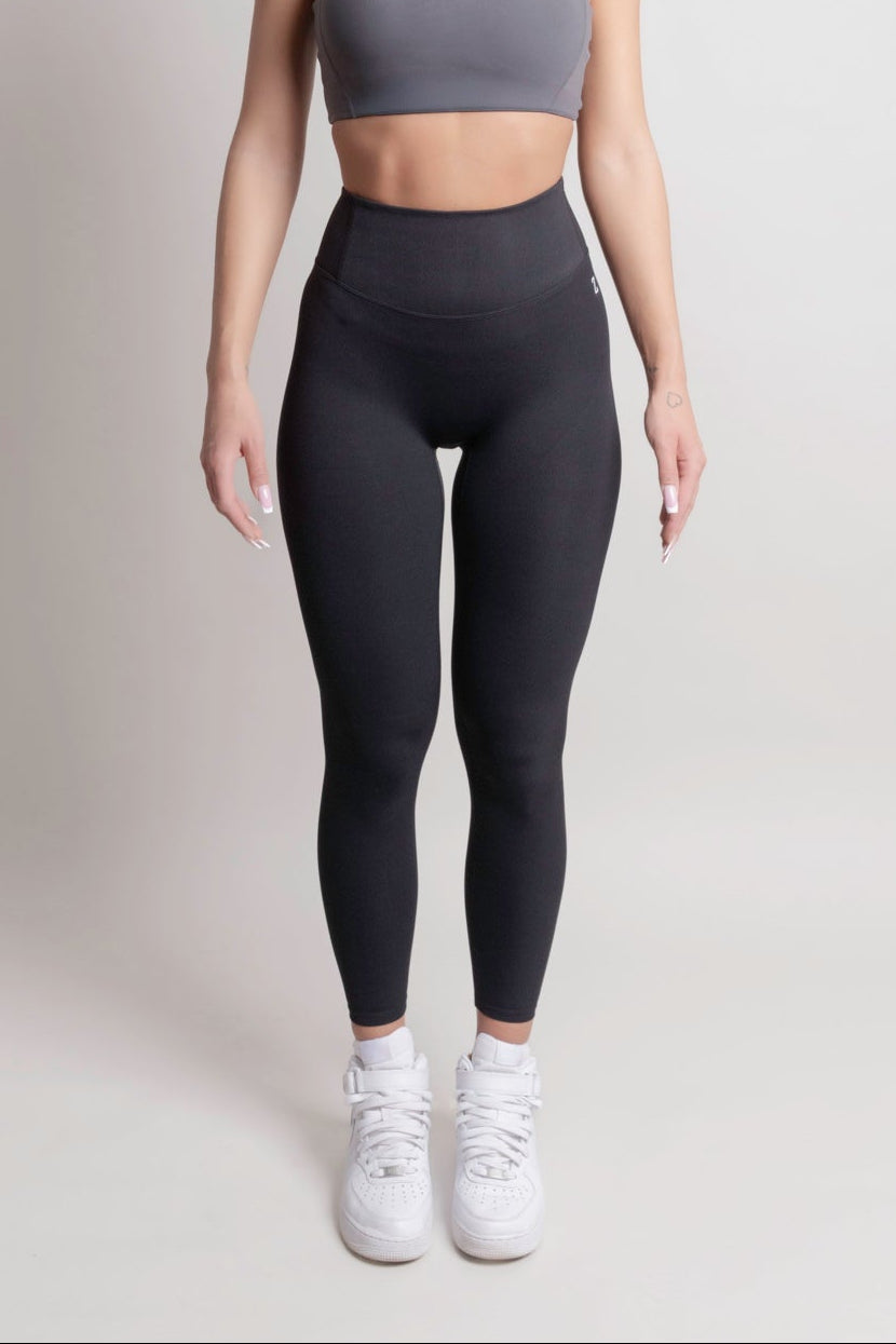 Woman wearing NOIR sport top and leggings front view by ZANOS Apparel