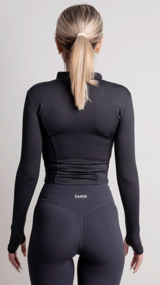 NOIR zip jacket black women seen from the back, showcasing a sleek silhouette and lightweight fabric.