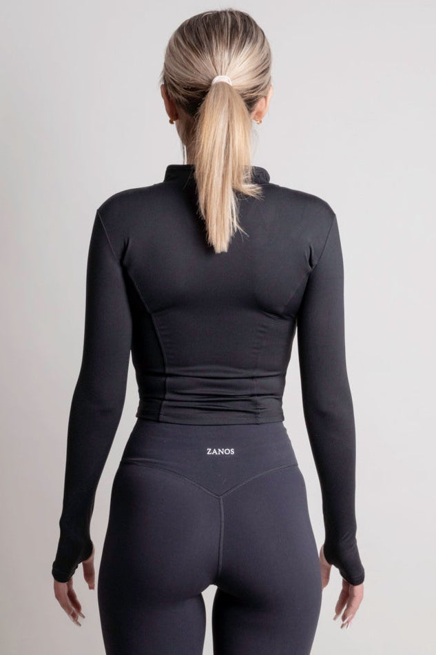NOIR zip jacket black women seen from the back, showcasing a sleek silhouette and lightweight fabric.