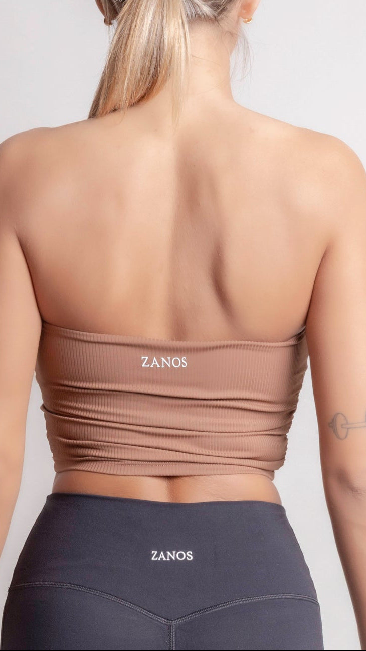 NOIR bandeau top earth brown women worn from the back, showcasing seamless design and subtle rib texture.