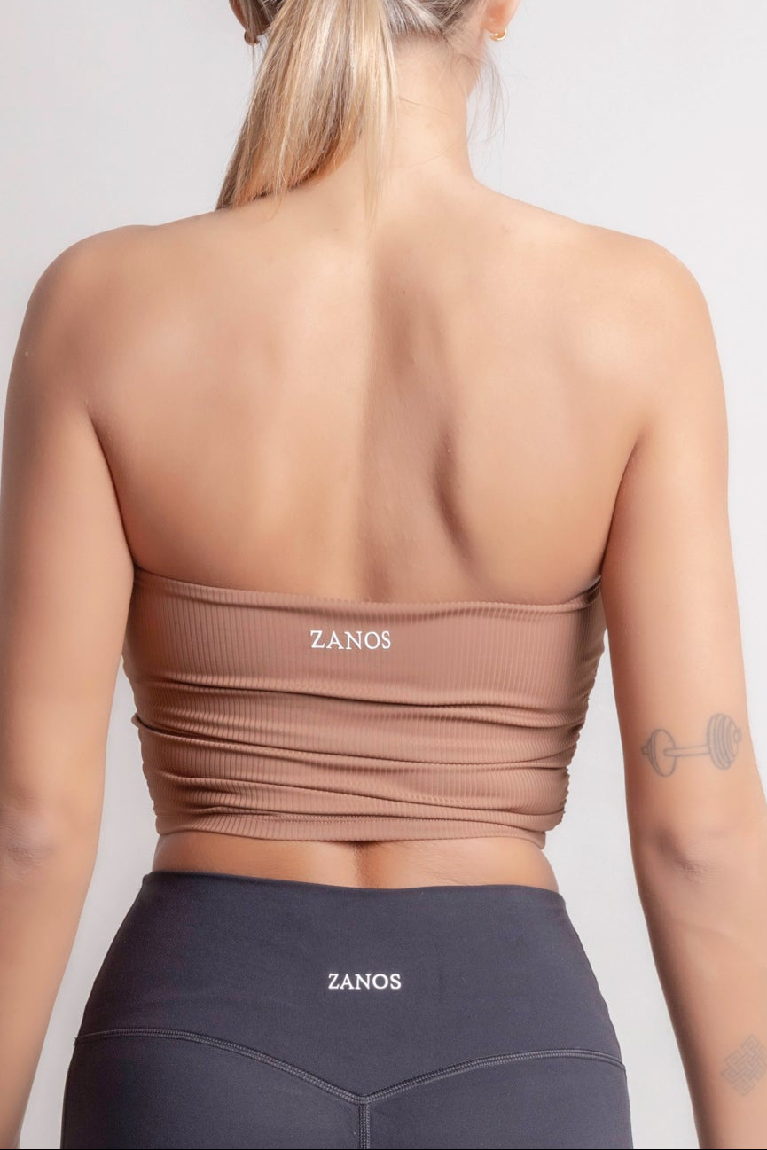 NOIR bandeau top earth brown women worn from the back, showcasing seamless design and subtle rib texture.