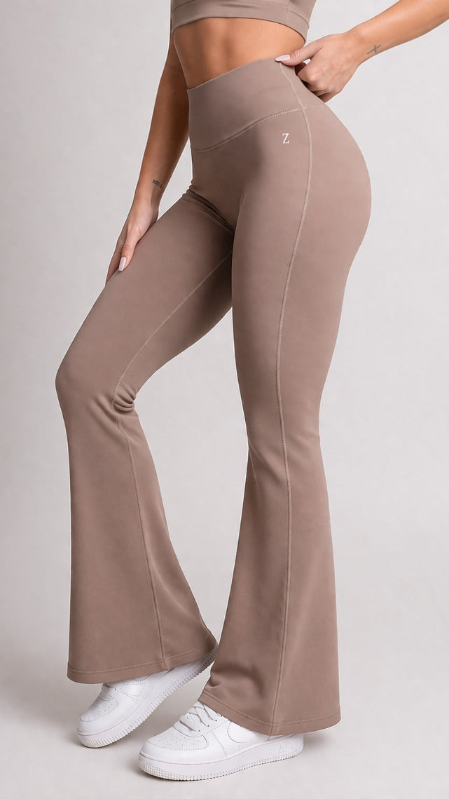 Woman wearing NOIR Flare Pants Brown with matching top, showcasing a flattering silhouette and stylish look.