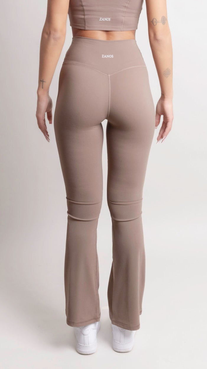 Model wearing NOIR Flare Pants Brown from ZANOS Apparel, showcasing the stylish high-waisted design and flared legs.