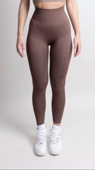 Women wearing NOIR Scrunch Leggings Mocha Brown, showcasing a flattering body-hugging fit and scrunch detail, paired with white sneakers.