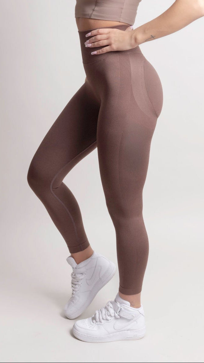 Model wearing NOIR Scrunch Leggings in Mocha Brown, showcasing the flattering scrunch detail and body-hugging fit.