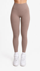 Woman wearing NOIR Yoga Leggings in Brown Mocha color with matching top, Front showcasing a flattering silhouette and stylish look.