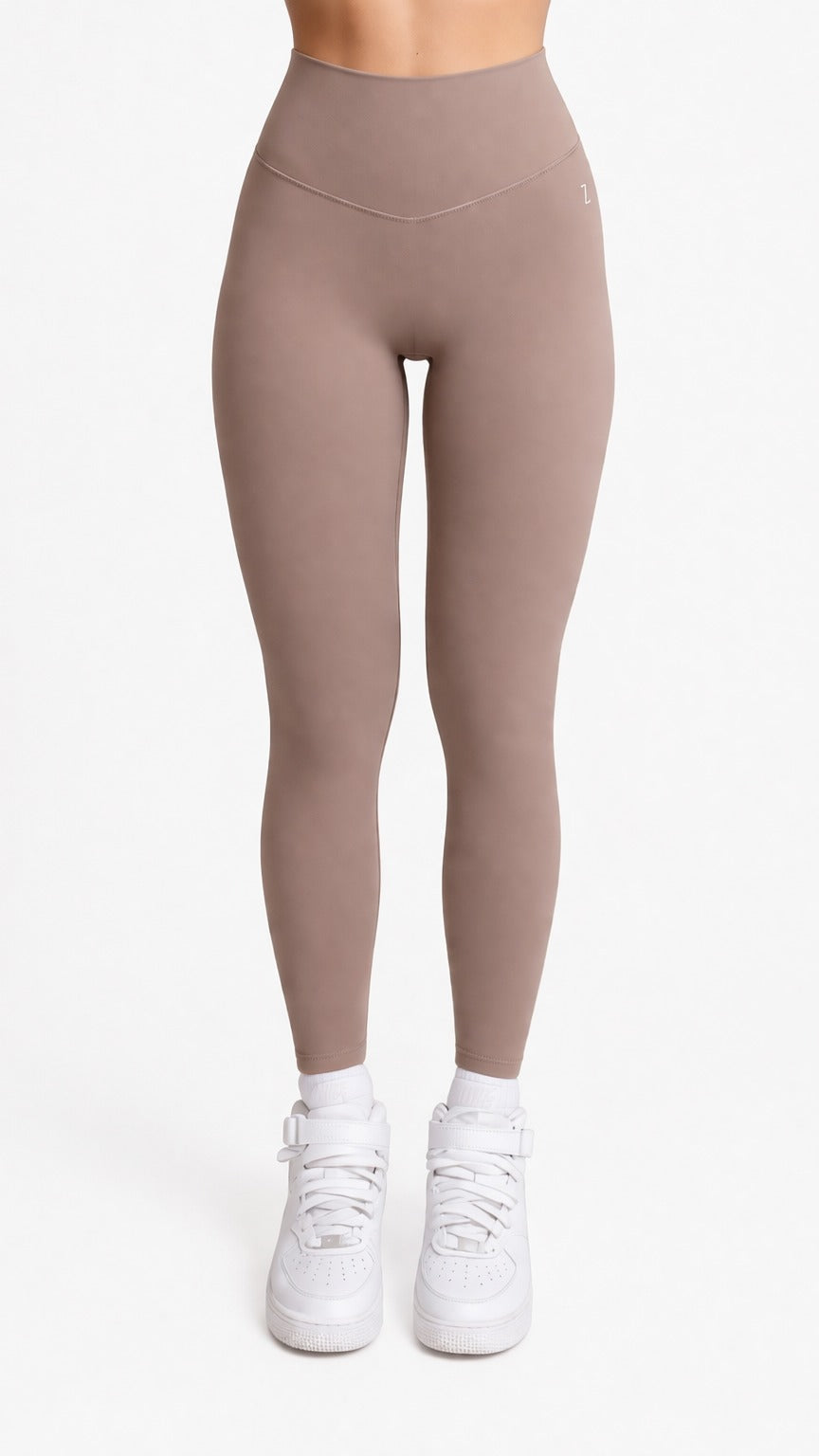 Woman wearing NOIR Yoga Leggings in Brown Mocha color with matching top, Front showcasing a flattering silhouette and stylish look.