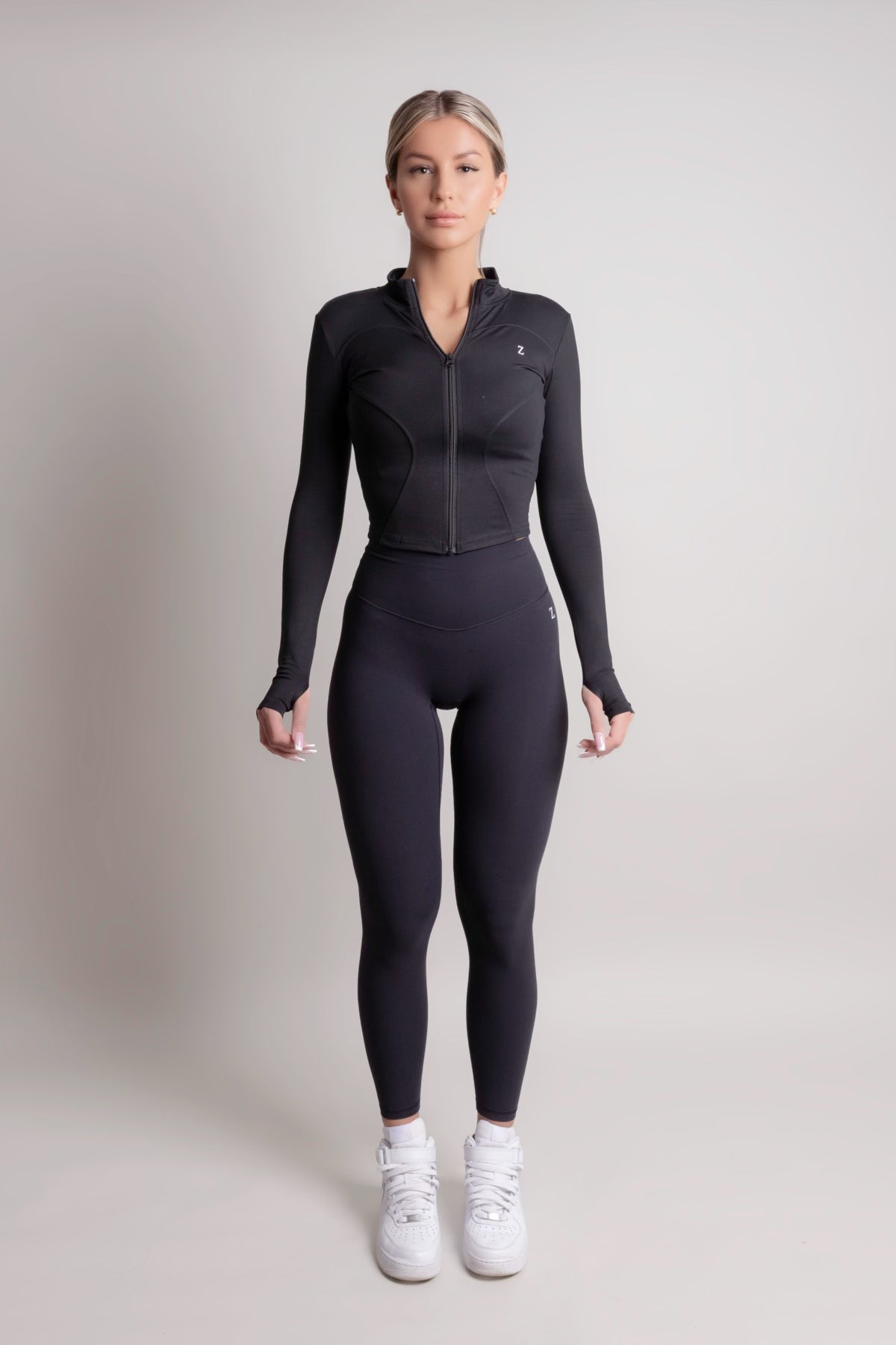 Person wearing noir yoga leggings for women by zanos on a plain background