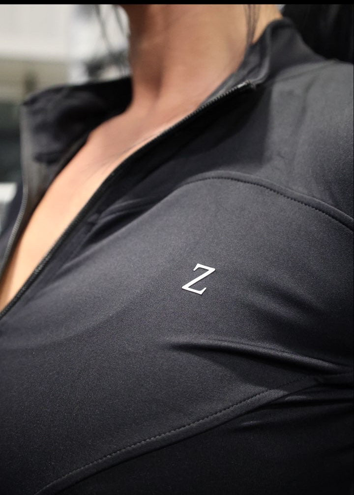 Close-up of a dark gray sleeve with a logo on a blurred background