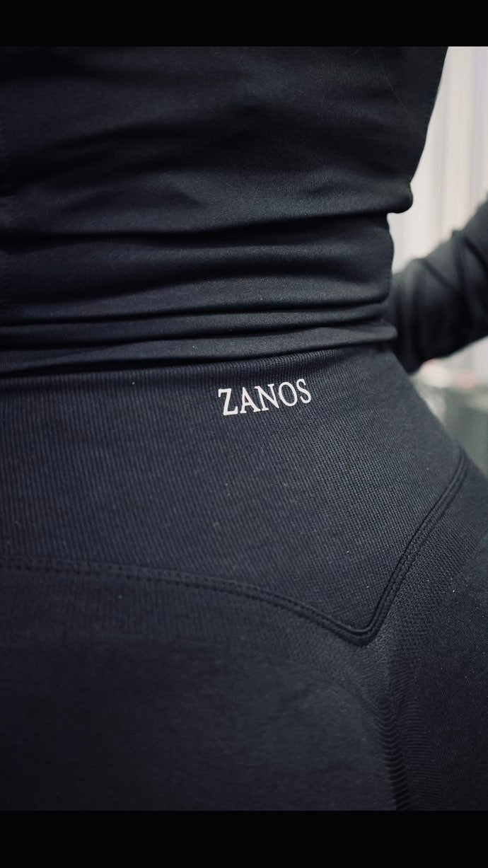 Black garment with 'ZANOS' branding on a blurred background