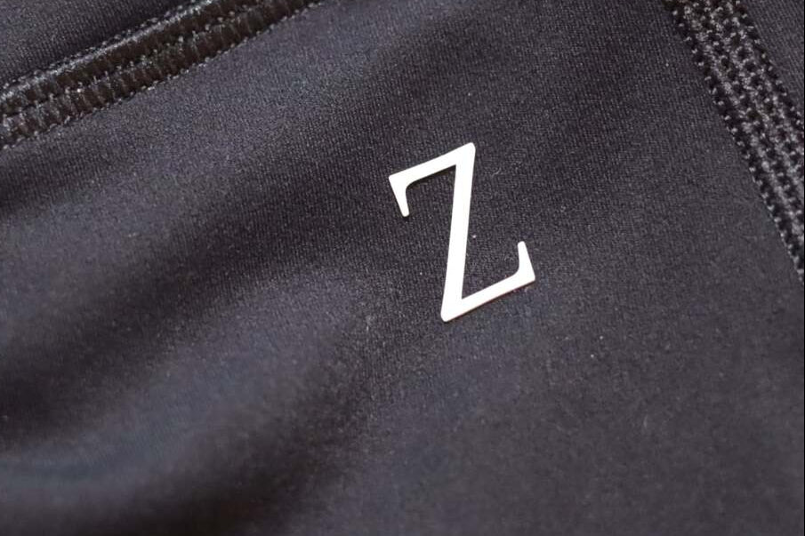 Close-up of a black fabric surface with a white 'Z' logo.