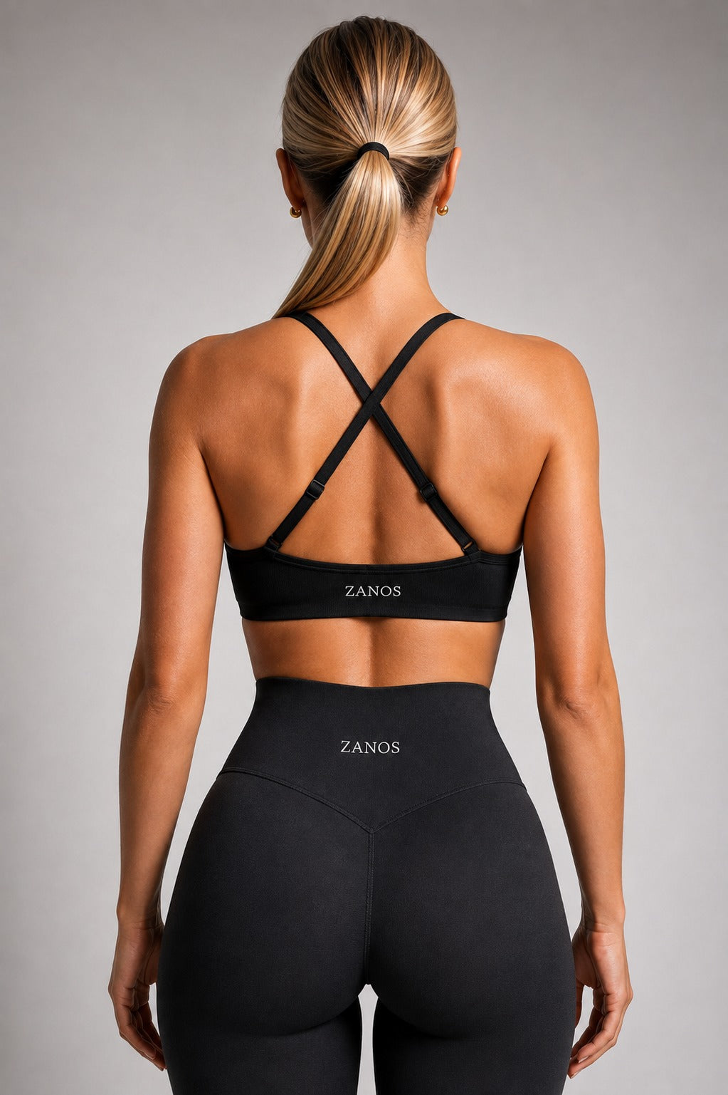 Side view of black NOIR Flow Bra showing the fitted cut and supportive underband